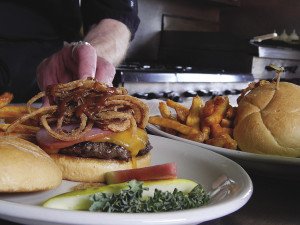 The Al Capone burger at Four Seasons in Finland is topped with Canadian bacon, cheddar cheese, onion straws and a whiskey steak sauce. | KELSEY ROSETH