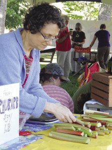 Judy Peterson, aka the Garlic Lady, setting out rhubarb. | KELSEY ROSETH