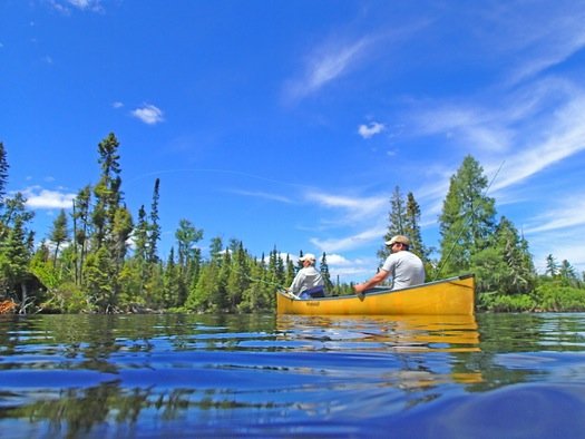 On a lake just off the Gunflint Trail in northeastern Minnesota, Bob Nasby of St. Paul cast a fly, while Joe Friedrichs awaited a smallmouth bass strike.