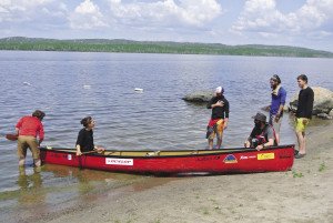 Members of the 2015 Canadian Expedition of the Year inspect their canoe on the shores of Gunflint Lake. | JOSEPH FRIEDRICHS.