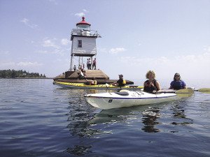 Kayakers paddle near the breakwall in Two Harbors. | SUBMITTED