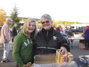 Volunteers Grace Ritchey and her grandma Robin Duchein help with distribution. | Breana Roy