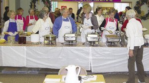 Beatrice Ojakanges starts the line at the Lutefisk, Salmon and Meatball Dinner in Duluth. | Submitted