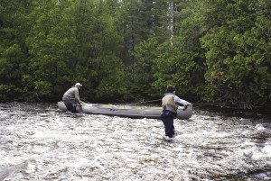 Devin Ellis fly fishes for brookies while guide Tyler Lancaster holds the canoe on the Keezhik River in 2007. | GORD ELLIS