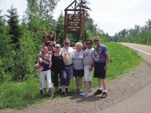 The Waver family poses in front of the Trout Lake Resort sign. | Submitted