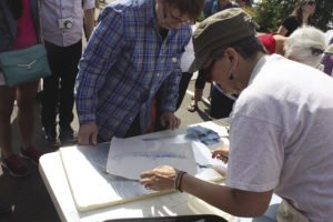 Cameron Norman leading Gyo-taku fish printing at the Grand Marais Art Festival. | Submitted