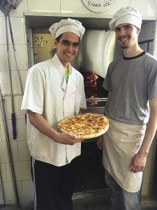  Two of Sydney’s pizza chefs show off their  handiwork in Grand Marais. | Submitted