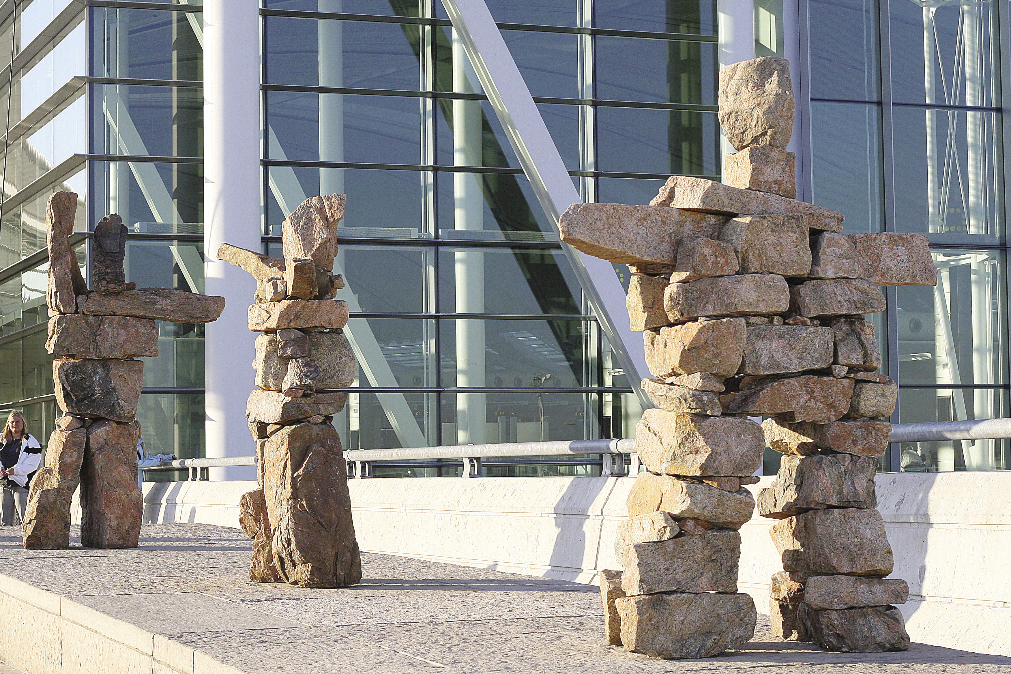 These three whimsical Inuksuit made of stacked orange granite stones greet passengers at the departure entrance at Terminal 1 of Toronto's Pearson International Airport.