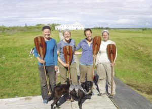 The group holding branded paddles at York Factory. (Steph, Chelsea, Tessa, Whitney & Avery the Dog). | SUBMITTED