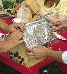 At Willow Springs Creative Centre, activities such as making rustic birdfeeders for a Christmas in July party occur. | SUBMITTED