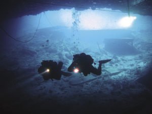 Divers brave frigid, dark waters to explore a shipwreck. | RYAN HAMLIN