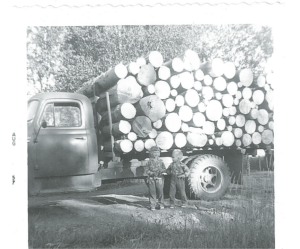 Two of Johnson’s children, Sandy and Rocky, with a load of peeled spruce in 1957. | COURTESY OF DUANE JOHNSON