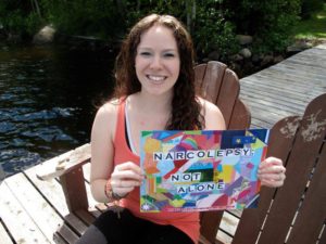 Breana displays her "Narcolepsy: Not Alone" campaign sign, an awareness campaign founded by Julie Flygare, fellow PWN and author of "Wide Awake and Dreaming: A Memoir of Narcolepsy." More than 1,000 PWN’s and their supporters have taken part in the campaign, sending in pictures from all 50 U.S. states and 37 countries around the world. | BREANA ROY