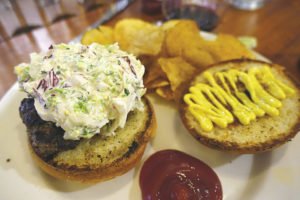 Insula’s Taj Mahal burger with Asian slaw, fresh mozzarella, and curry mayo, with a side of house made seasoned chips. | SUBMITTED