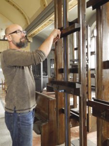 Artist and academy owner, Jeffrey T. Larson showing easels made from church pews. | KELSEY ROSETH