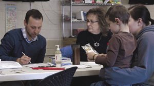 Dental therapist Bill Heitzman and NSHCF’s Oral Health Task Force  coordinator Georgene Daubanton at a school screening.  | NORTH SHORE HEALTH CARE FOUNDATION