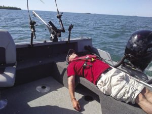 Author Gord Ellis grabs a little shut eye on a boat. | GORD ELLIS