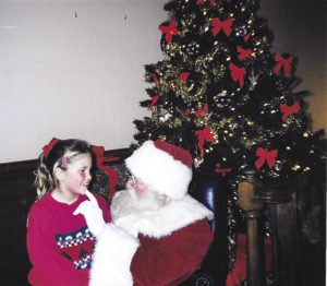 Casey Fitchett sits on Santa’s lap. | CASEY FITCHETT