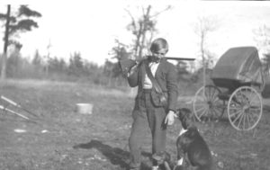 Alec Boostrom with his dog as depicted in the book Boundary Waters Boy