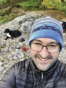 Eric Chandler is chilly at suppertime at Harness Lake at the end of day three, a long 12-mile day hiking the Kekekabic Trail. | ERIC