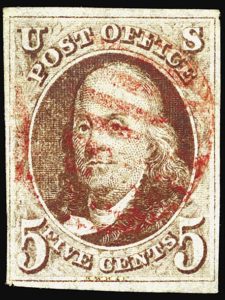 One of the first U.S. postage stamps, the 5 cent Benjamin Franklin, issued in July 1847. | WIKIMEDIA