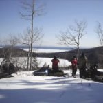 Snowmobilers on the Grand Portage trail overlooking Teal Lake.