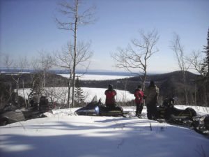Snowmobilers on the Grand Portage trail overlooking Teal Lake.