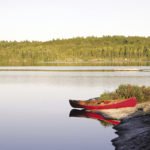 A canoe beached on a perfect sloping rock in the Northern Wilds.