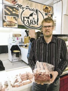Mike Visser, of My Pride Farm, holding veal prime rib.