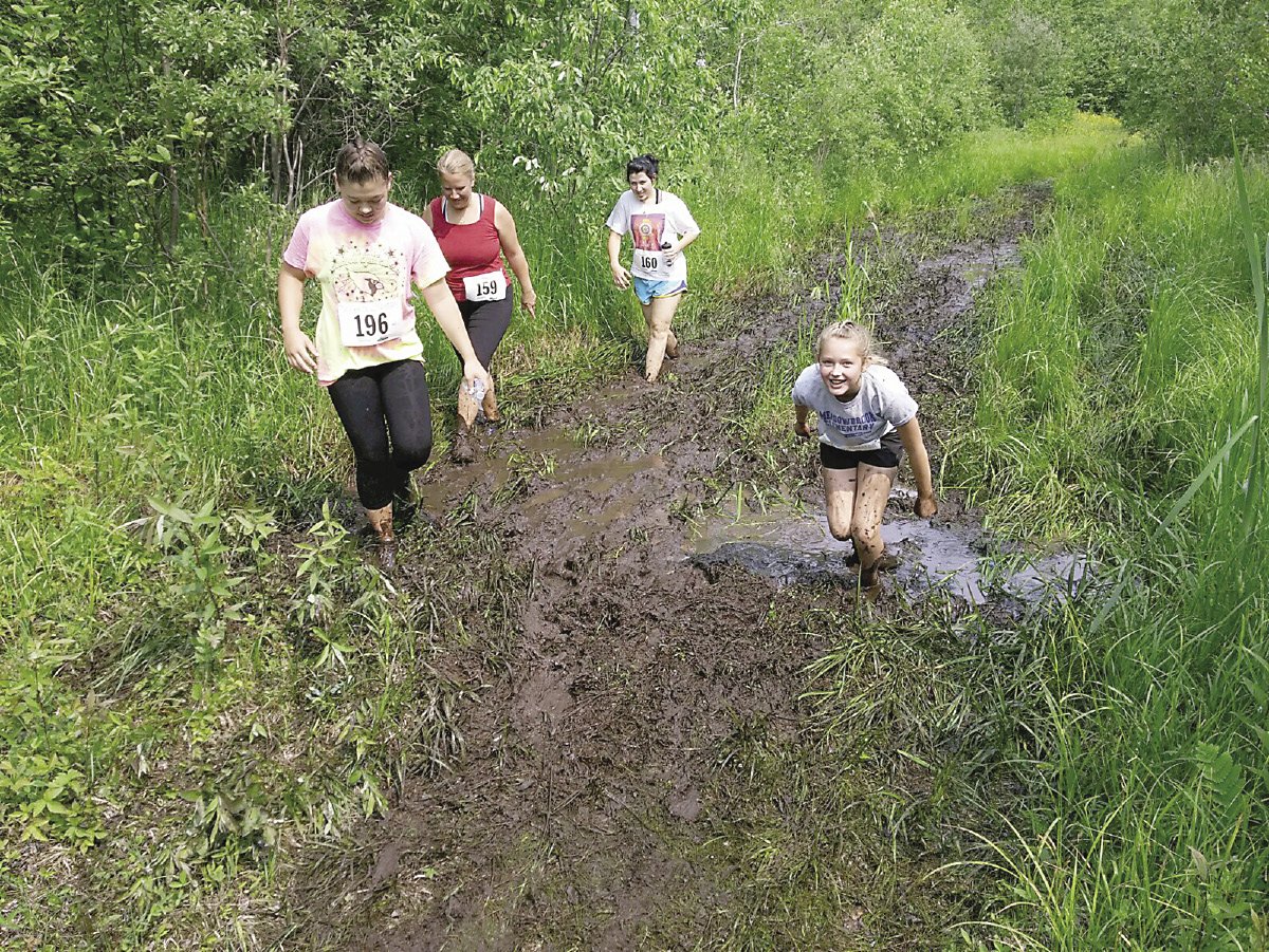 These walkers are following race founder Jan Horak’s advice: stay to the side of the mudholes. | RHONDA SILENCE