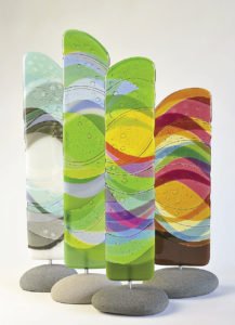 From 1985 to about 2010, Seaton’s main focus was on watercolors. Now, she also creates fused glass totems mounted in Lake Superior rocks.